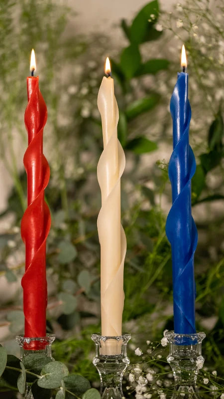 Lit red white blue spiral beeswax candles