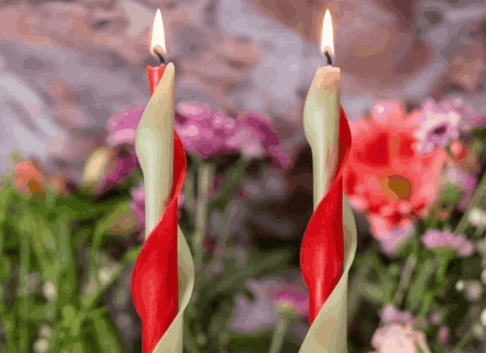 Lit red and ivory spiral beeswax candles